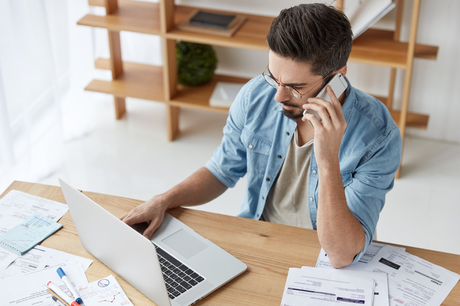 How To Create Retail Copywriting That Gets Results bearded skilled young talented copywriter works on new article keyboards at laptop has phone conve 1