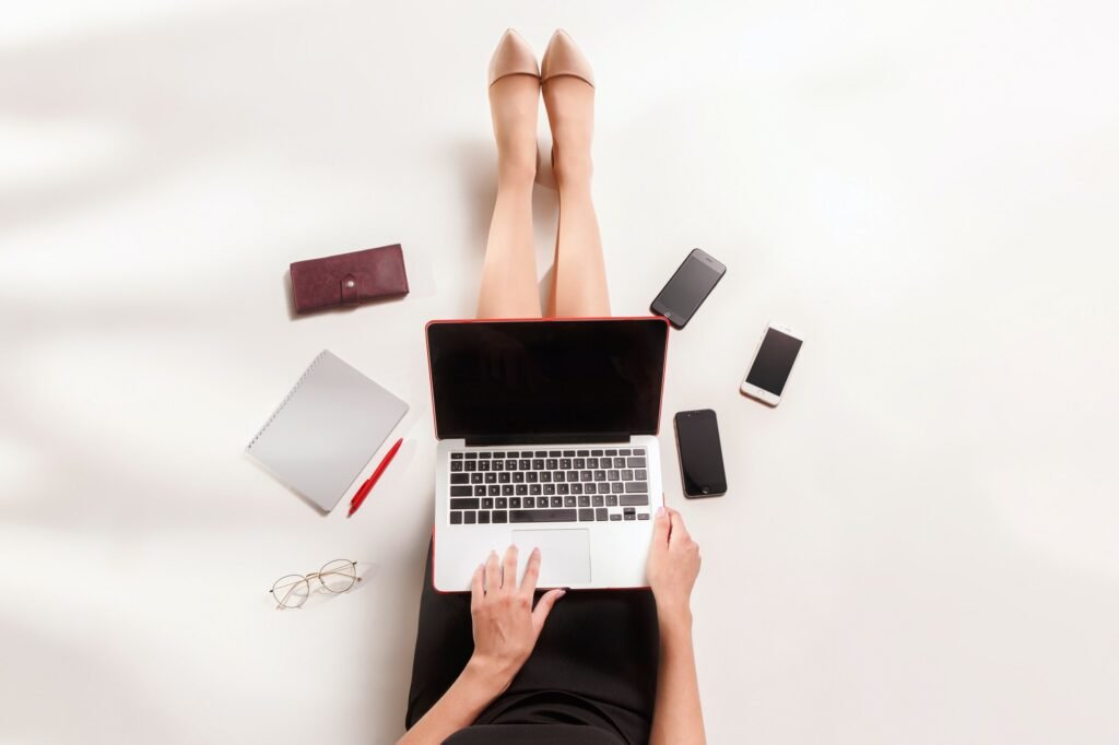 fashion blogger writing on laptop computer